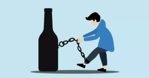 A cartoon of a man chained to a liquor bottle by his leg. He is trying to escape but cannot.